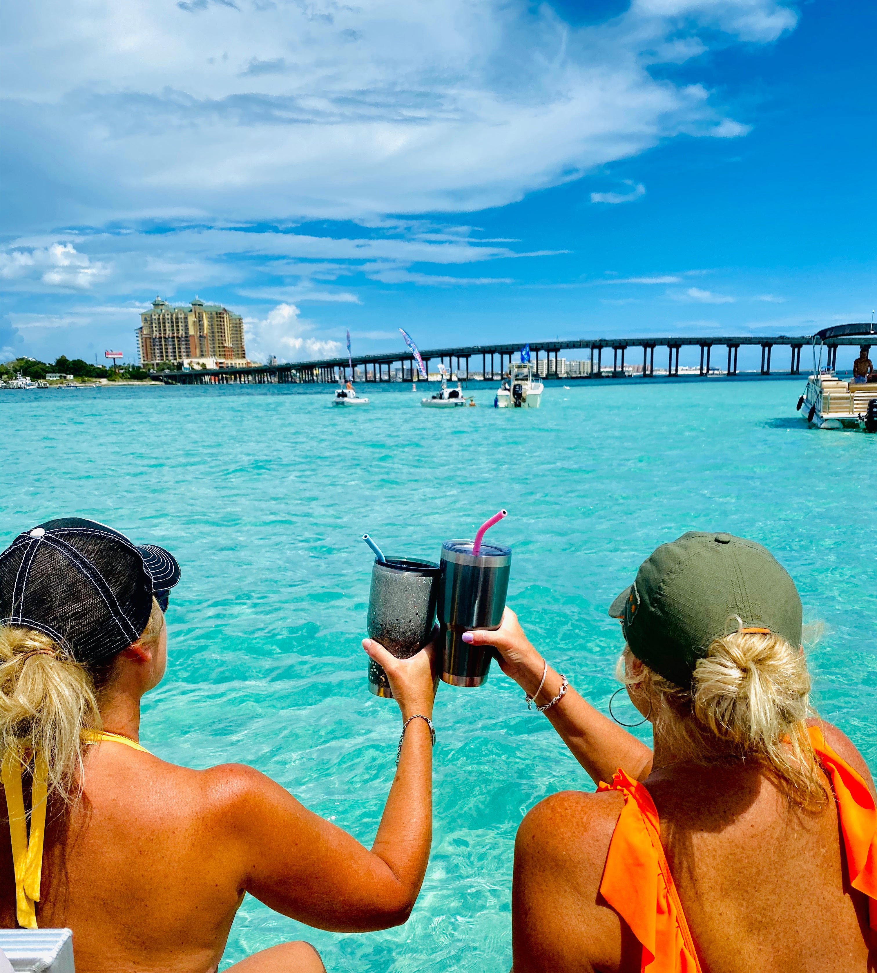 Two Women Cheersing Cups at Crab Island 